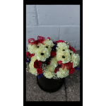 Bouquet of cream, red, and purple flowers in a black container