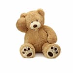 Plush teddy bear sitting with one paw raised