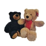 Two plush teddy bears, one black and one tan with a red ribbon