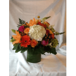 Colorful mixed flower arrangement in a green vase