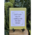 Framed quote sign on an easel with green plants in the background