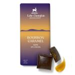 Bourbon caramel dark chocolate bar with broken squares and caramel on white background