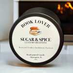 A black-lidded candle jar with a book-themed label.