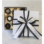 Box of assorted chocolates tied with black and white ribbon