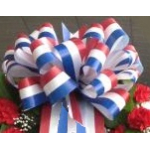 Red, white, and blue ribbon bow on a floral arrangement