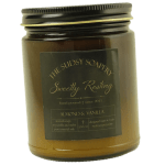 Amber jar candle with a black lid and label