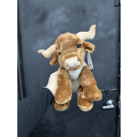 Brown plush cow toy with white horns and snout being held up