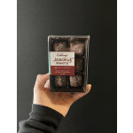 Hand holding a box of milk chocolate sea salt caramels