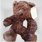 Brown plush teddy bear with a hanging tag