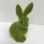 Green fuzzy bunny figurine with black eyes