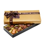 Box of assorted chocolates with a gold lid and brown ribbon