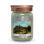 Green jar candle with copper-tone lid and a landscape label reading Sage Serenity.