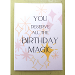 Birthday card with text 'You deserve all the birthday magic' and pastel starburst shapes on a white background