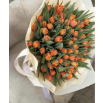 Bouquet of orange tulips wrapped in cream paper