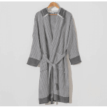 Gray and white striped robe with belt hanging on a wooden hanger against a light wall