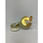 Two small candle jars with gold lids and wooden spoons tied on top