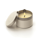 Lit candle in a round metal tin with a lid leaning beside it
