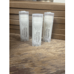 Three peppermint lip balm tubes on a wooden surface