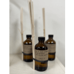 Amber reed diffuser bottles with black caps and reed sticks