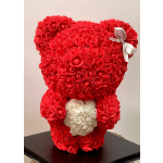 Red teddy bear made of roses with a white rose heart on its chest