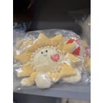 Plush sun-shaped toy in a clear plastic bag with a heart patch