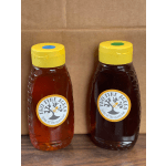 Two honey jars with yellow lids and bee labels