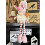 Pink plush bunny figurine holding a carrot decoration