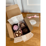 Box of assorted chocolate truffles with a pink ribbon and gift tag