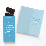 Blue gift box with dark chocolate pieces and a matching card