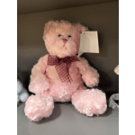 Pink teddy bear with a plaid bow and hanging tag