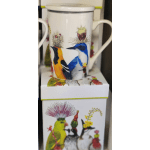 White mug with colorful bird illustrations and cactus designs