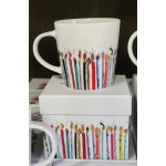 White mug with colorful candle illustrations on the side