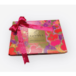 Box of assorted chocolates tied with a pink ribbon