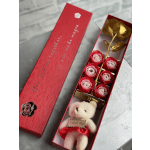 Red gift box with paper roses and a small teddy bear