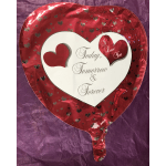 Heart-shaped red foil balloon with a love message