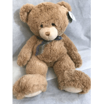 Plush teddy bear with a ribbon around its neck