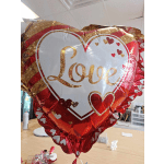 Heart-shaped red foil balloon with the word Love