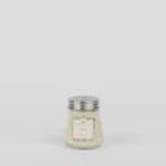 Small white candle in a glass jar with a metal lid