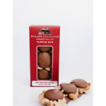 Box of milk chocolate turtle bars with chocolates spilled beside it