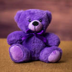 Purple teddy bear with a satin ribbon