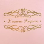 Pink floral boutique logo with gold decorative text