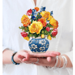 Colorful bouquet of roses in a blue floral vase
