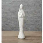 White religious statue on a wooden surface