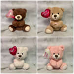 Four teddy bears holding heart balloons on a marble background
