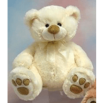 Cream teddy bear with a ribbon bow sitting against a pastel background