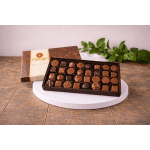 Box of assorted chocolates on a white round stand