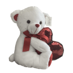 White teddy bear holding a red sequined heart with a ribbon
