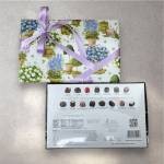 Gift box with lavender ribbon beside a box of assorted chocolates