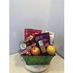 Gift basket with apples, citrus, and packaged snacks in a green container