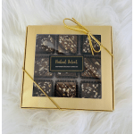Gold gift box of chocolate truffles with a ribbon bow